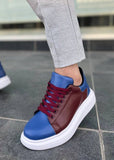 Blue and brown sneakers with white soles worn on a tiled floor.
